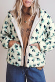 Woman in white floral sherpa hooded jacket, open front with hands in pockets