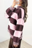 Woman wearing fuzzy knit mock-neck sweater with dark plum and light pink stripes, paired with brown pants.