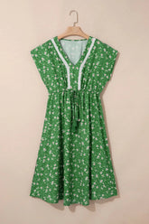 Green floral dress on a beige background