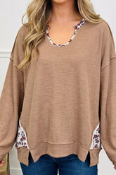 Women's beige ribbed tunic top with floral U neck and side trim, front view