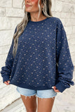 Women's navy floral print oversized sweatshirt, front view with denim shorts