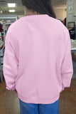 Women's plus size pink crewneck sweatshirt with blue jeans, back view