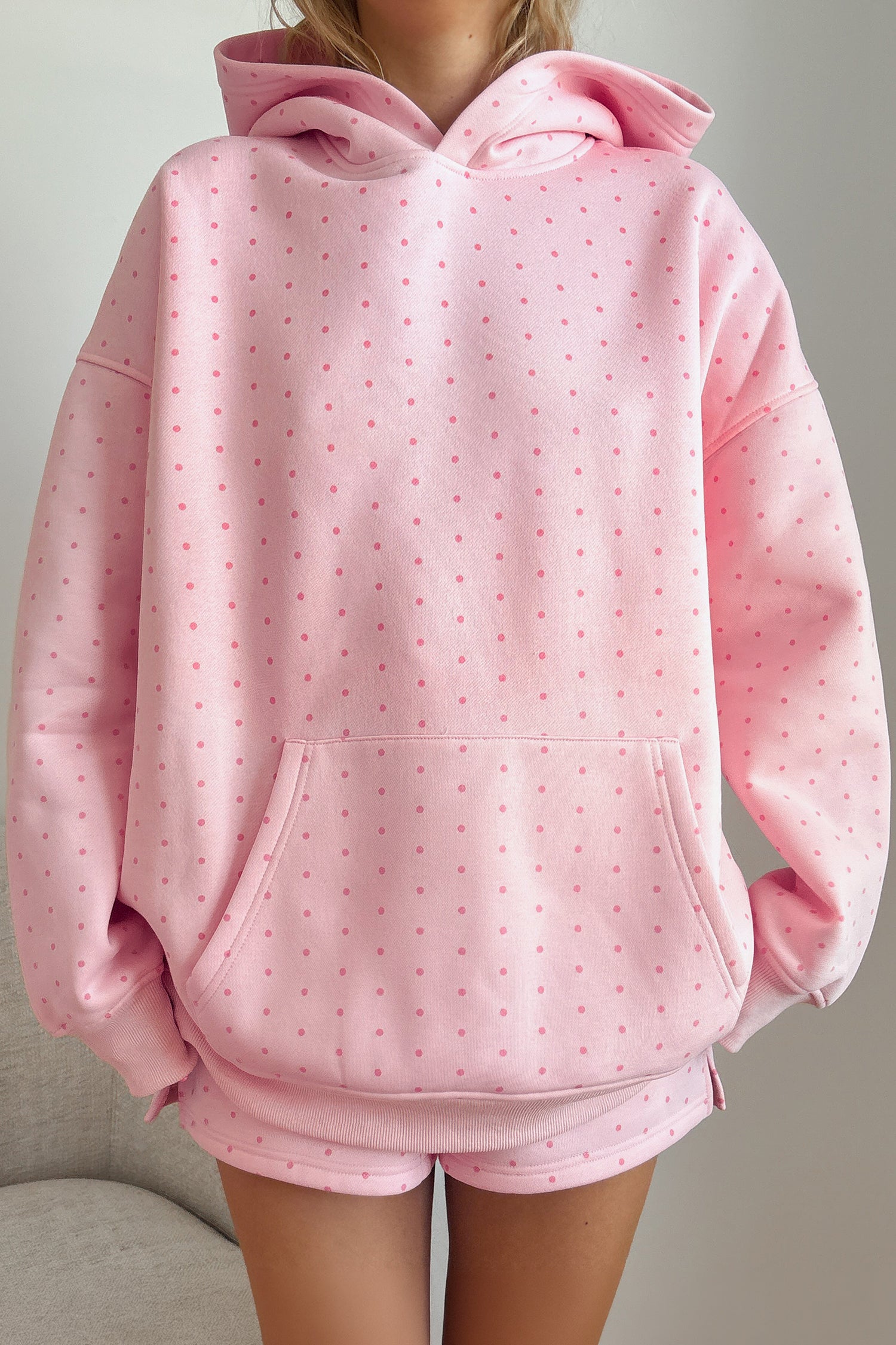 Women's pink polka dot oversized hoodie and shorts set, front view