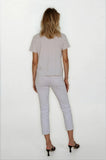 Person wearing a light gray outfit on a white background