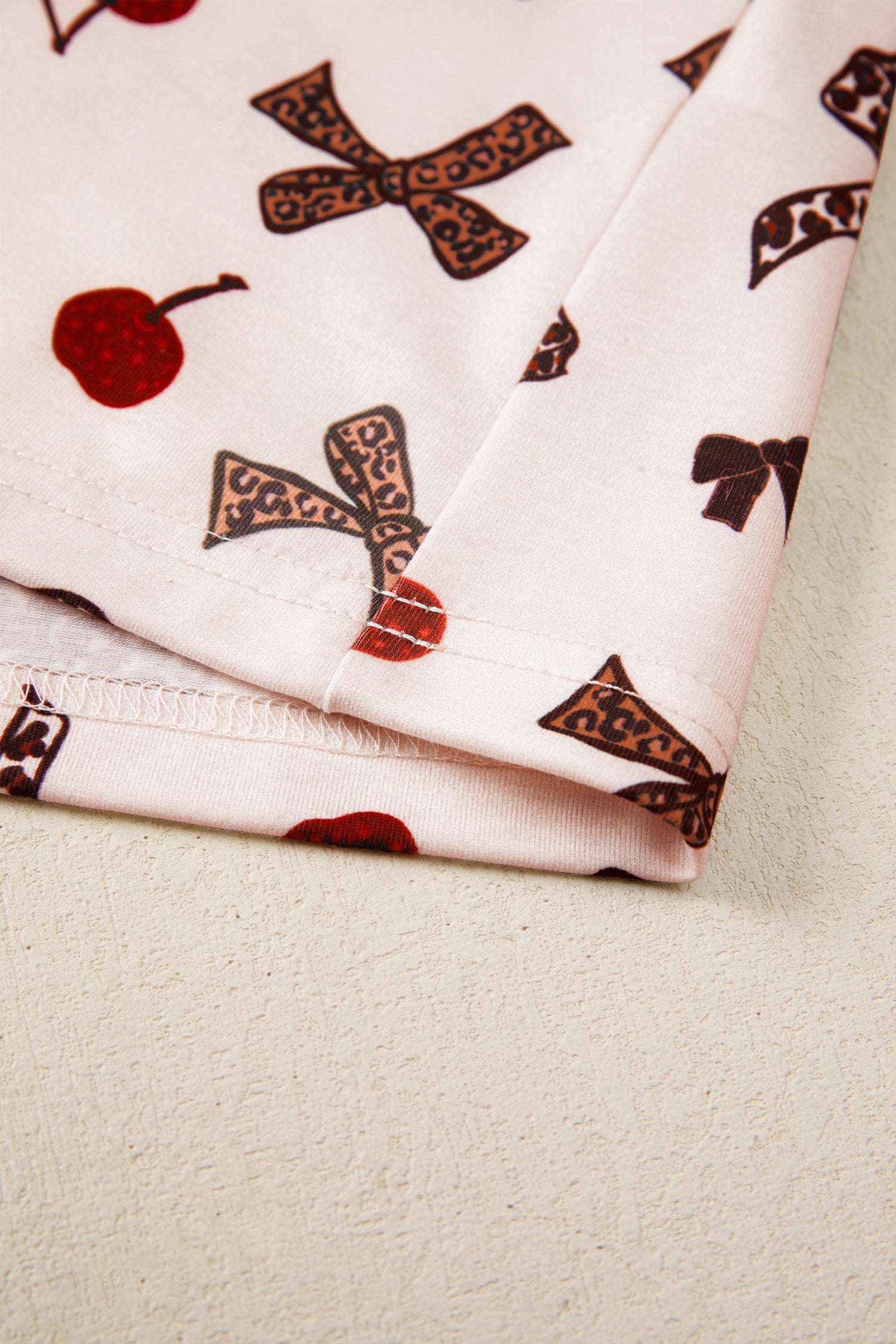 Folded fabric with brown patterns on a beige surface