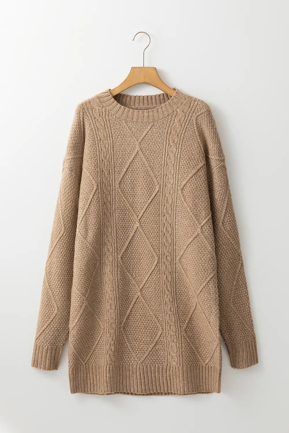 Beige knitted sweater on a wooden hanger against a white background