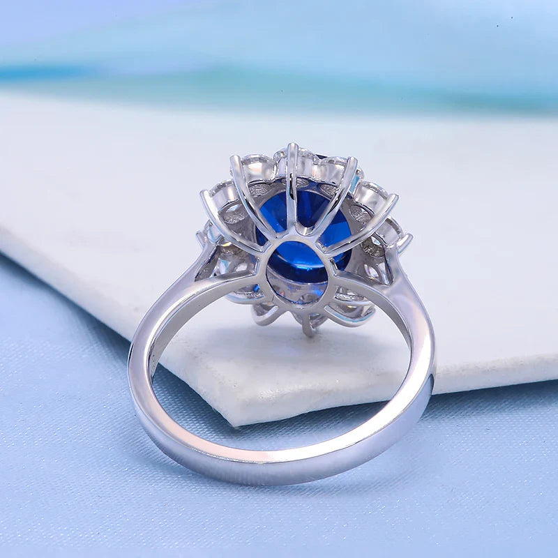 Silver ring with a blue gemstone on a light blue background