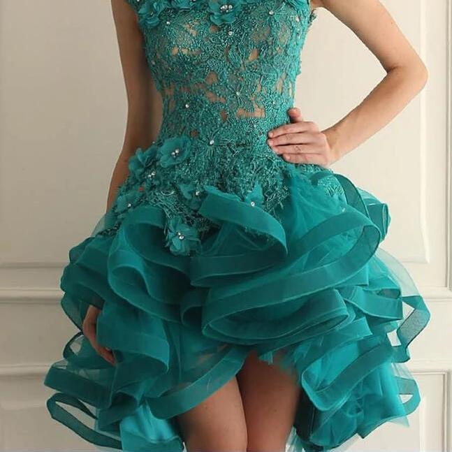 Teal lace dress with ruffled skirt on a neutral background