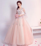 Woman in a floral evening gown holding flowers on a white background