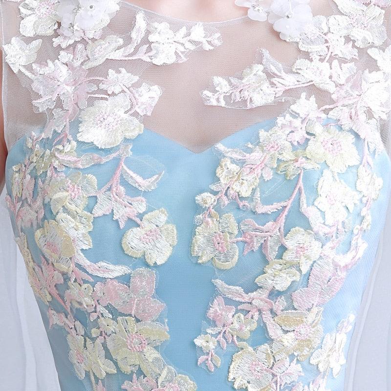 Close-up of a dress with floral lace details on a light blue background