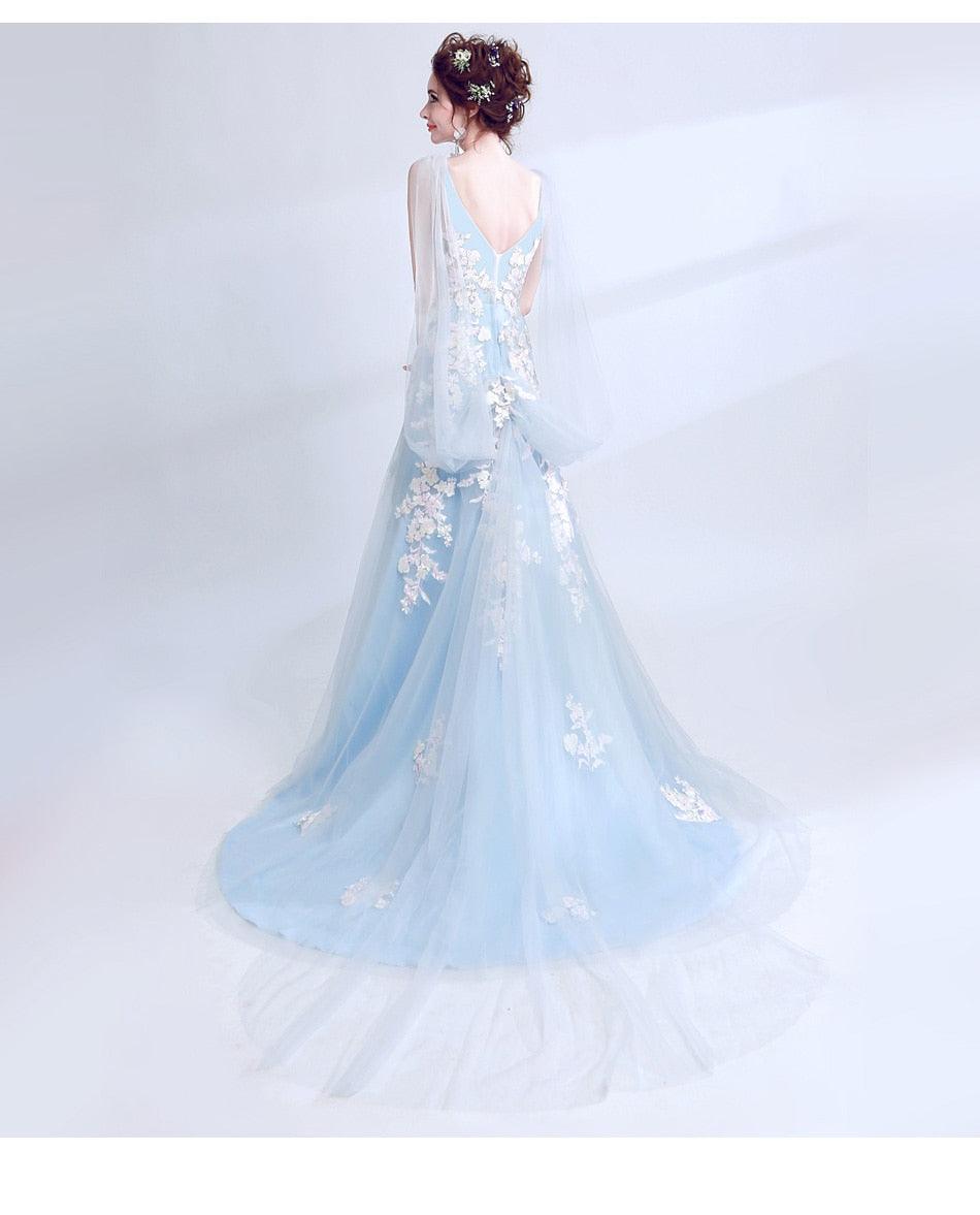 Light blue evening gown with floral details on a white background