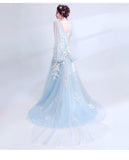 Light blue evening gown with floral details on a white background
