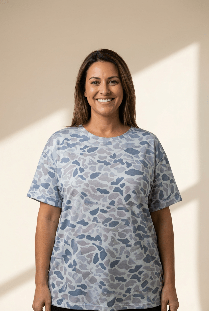 Woman wearing a blue patterned shirt against a neutral background