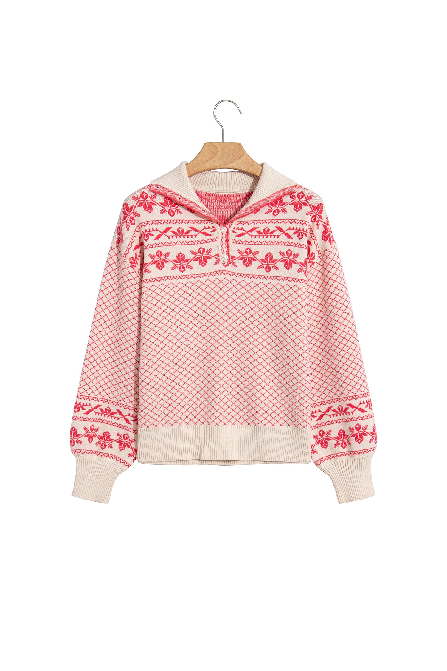 A pink and cream knit pullover sweater with a Fair Isle pattern, hanging on a wooden hanger against a plain white background.