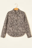 Long-sleeve button-front jacket with gray and beige abstract pattern on a wooden hanger.