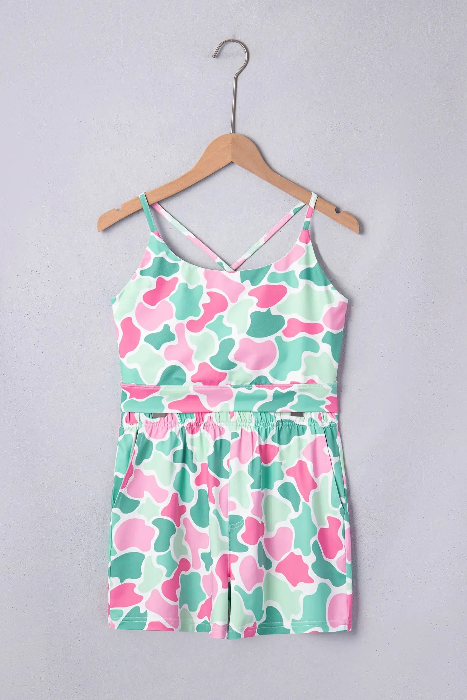 Floral dress on a hanger against a gray background