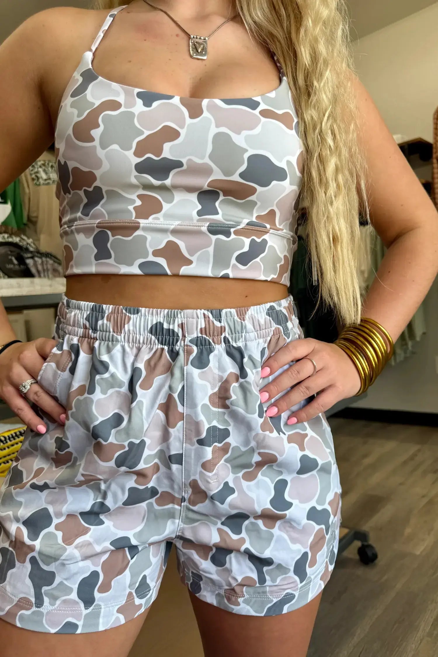 Person wearing a camouflage-patterned outfit indoors
