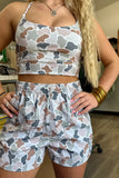 Person wearing a camouflage-patterned outfit indoors