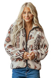 A woman with long blonde hair wearing a cream-colored fleece zip-up jacket with a brown and black geometric Southwestern pattern, paired with blue jeans, against a solid white background.