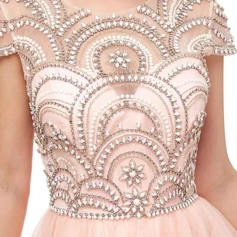 Close-up of a pink dress with intricate silver beadwork on a white background