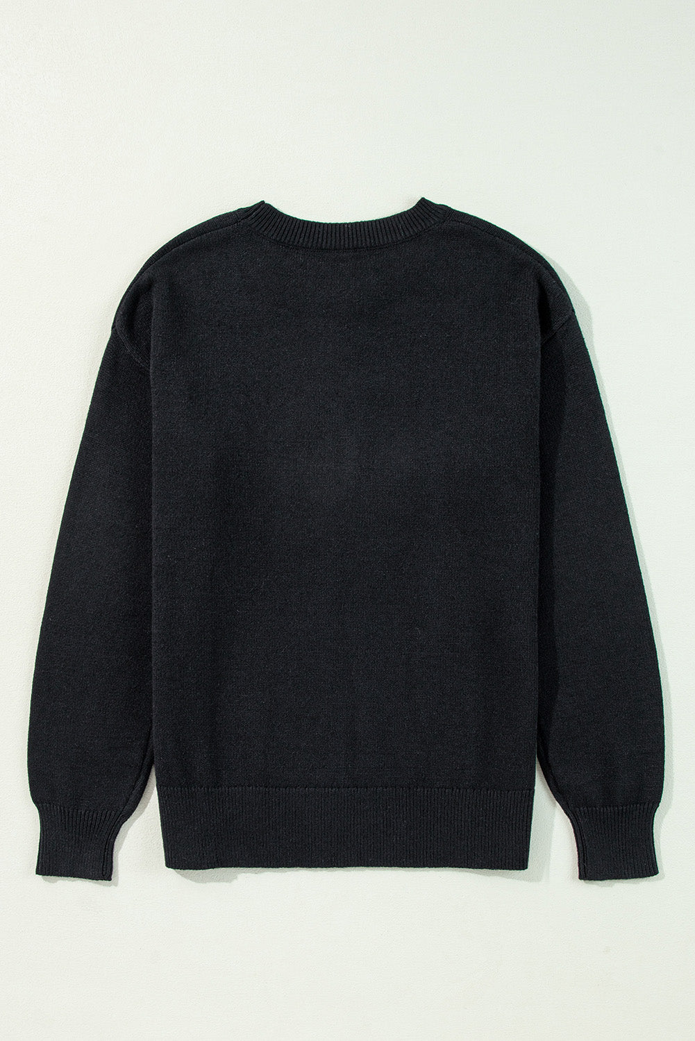 Black sweater on a light gray background