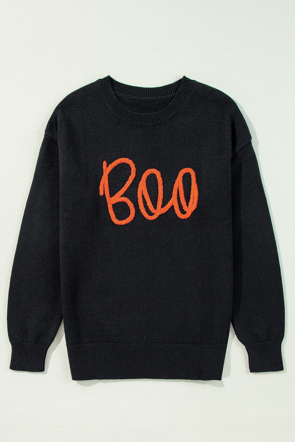 Black sweatshirt with orange 'Boo' text on a light gray background