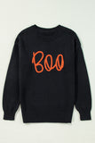 Black sweatshirt with orange 'Boo' text on a light gray background