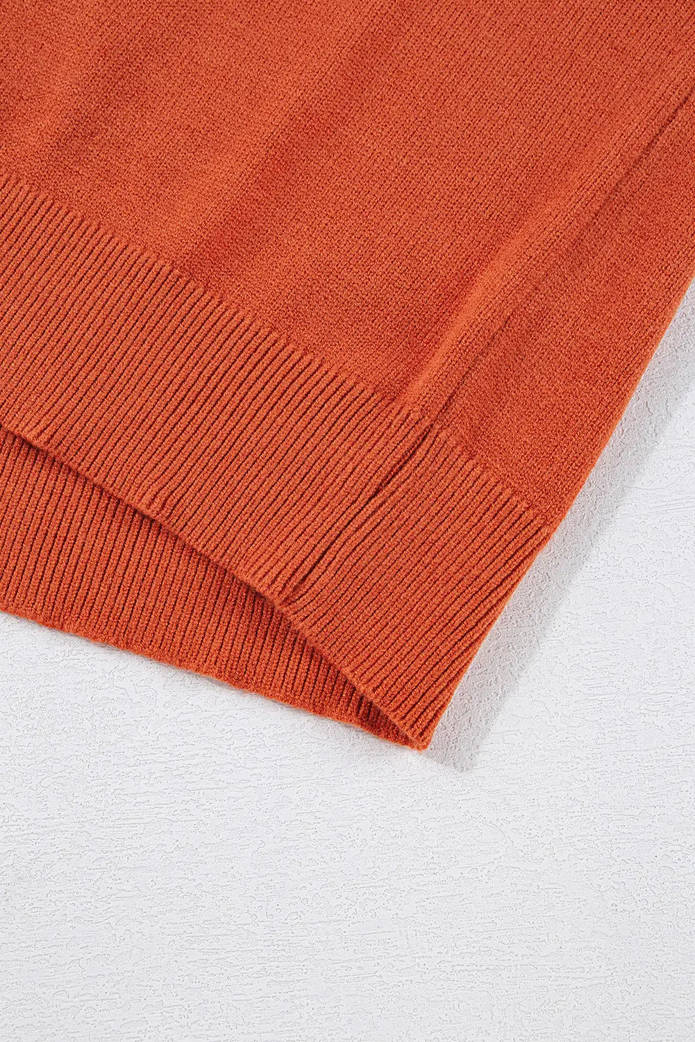 Close-up of an orange knitted fabric on a white background