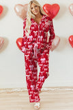 Woman wearing a red pajama set with white bows, surrounded by heart-shaped balloons.