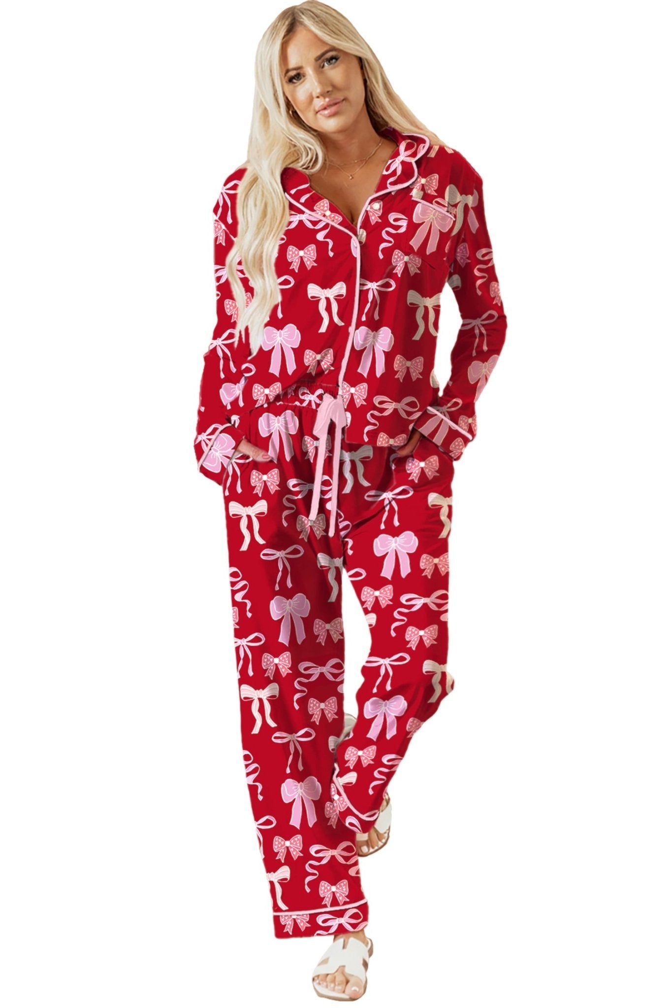 Woman wearing a red pajama set with white bows on a white background