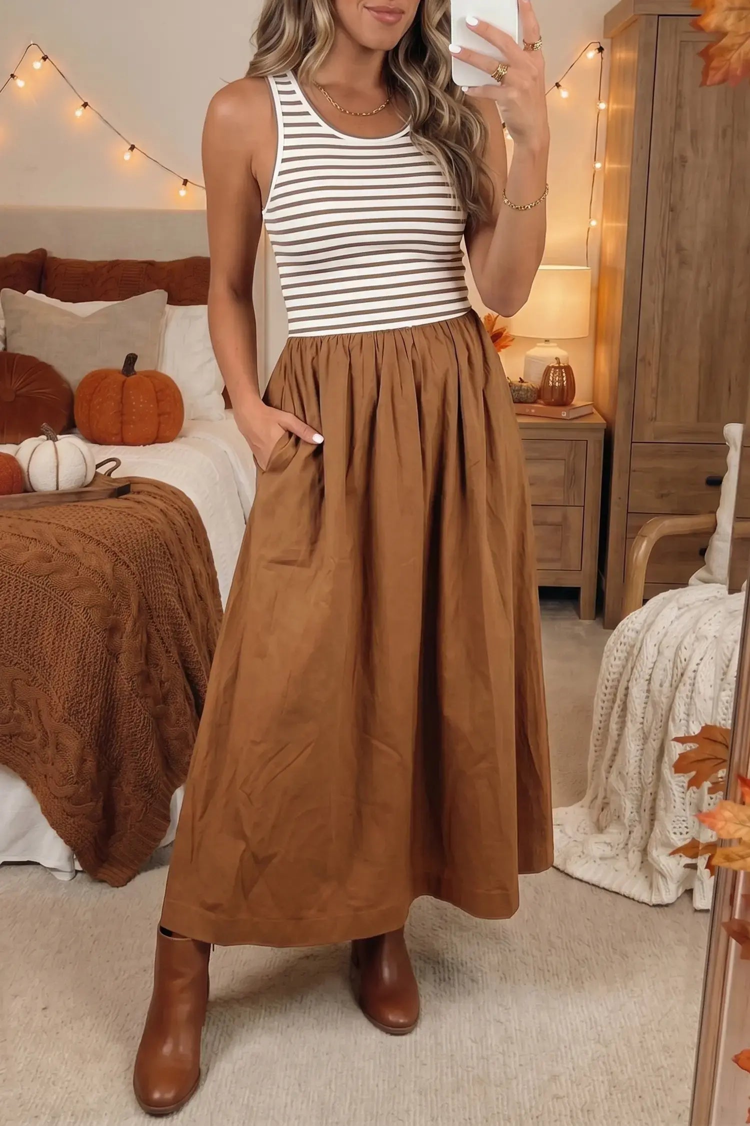 Woman taking a selfie in a bedroom with autumn decorations