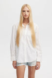 Person wearing a white shirt and denim shorts on a plain background