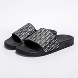 Black slides with patterned straps on a white background