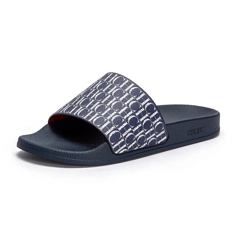 Navy slide sandal with patterned strap on a white background