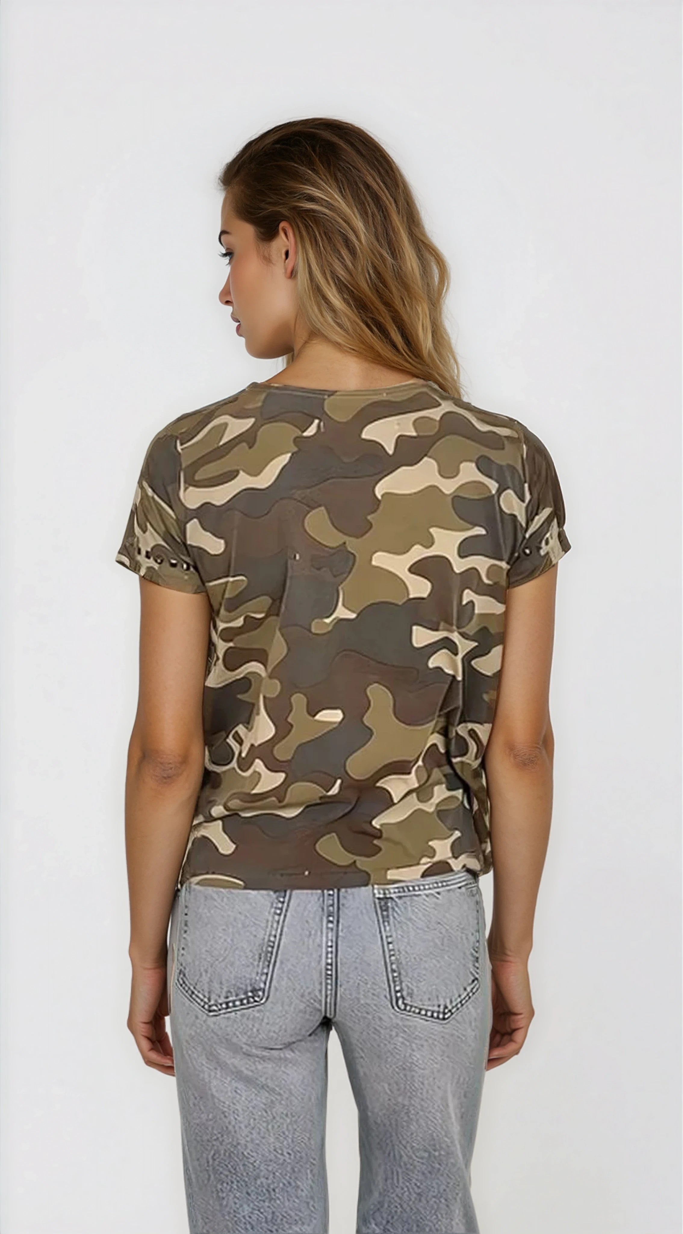 Person wearing a camouflage t-shirt and light blue jeans on a white background