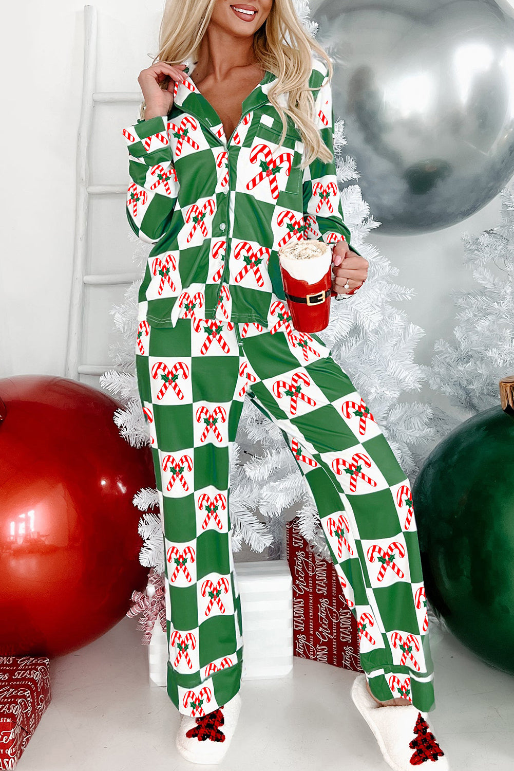 Person wearing a green and red checkered pajama set with festive decorations.