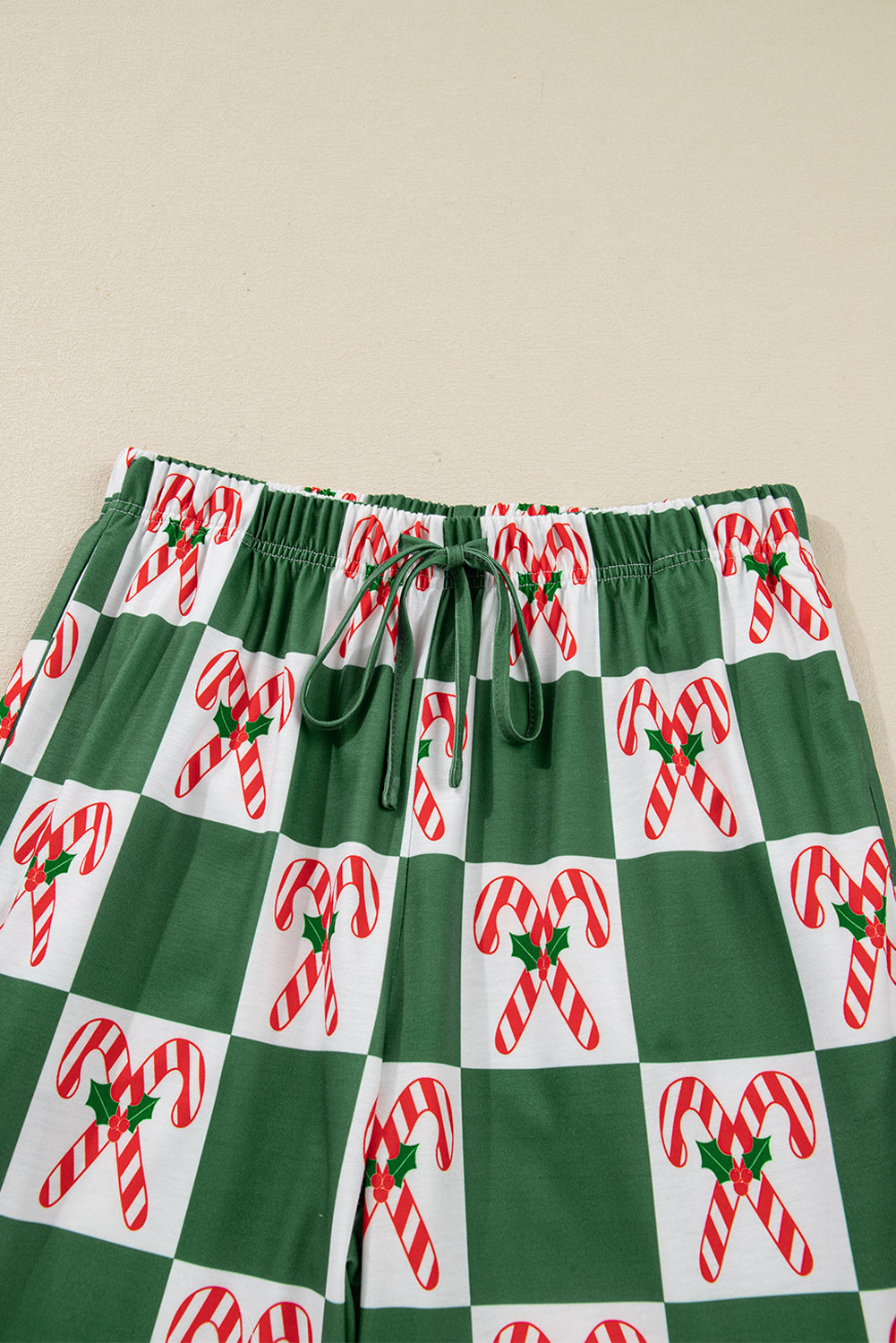Green shorts with candy cane pattern on a beige background