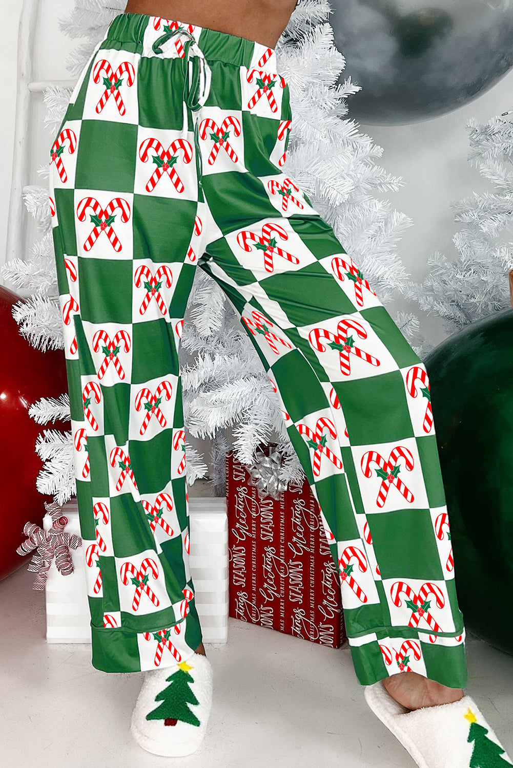 Green-white checkered candy cane pants with Christmas tree and gifts.