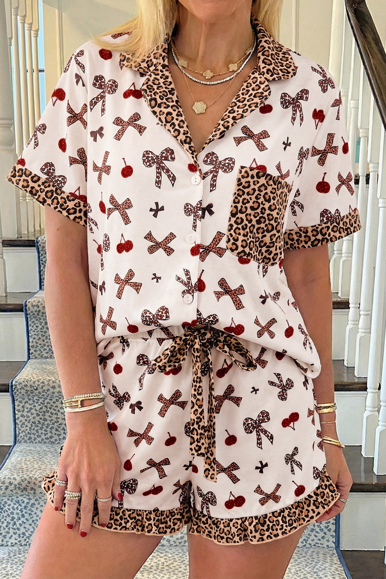 Woman wearing a patterned outfit with bows and leopard print details.
