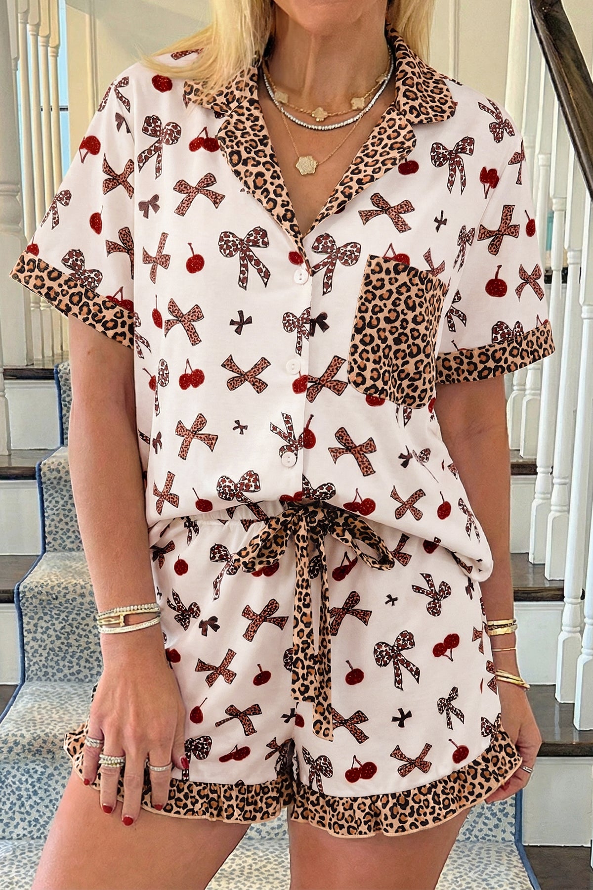 Woman wearing a patterned outfit with bows and leopard print details.