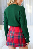 A woman shown from the back wearing a dark green knit sweater and a red plaid mini skirt in a bright indoor setting.