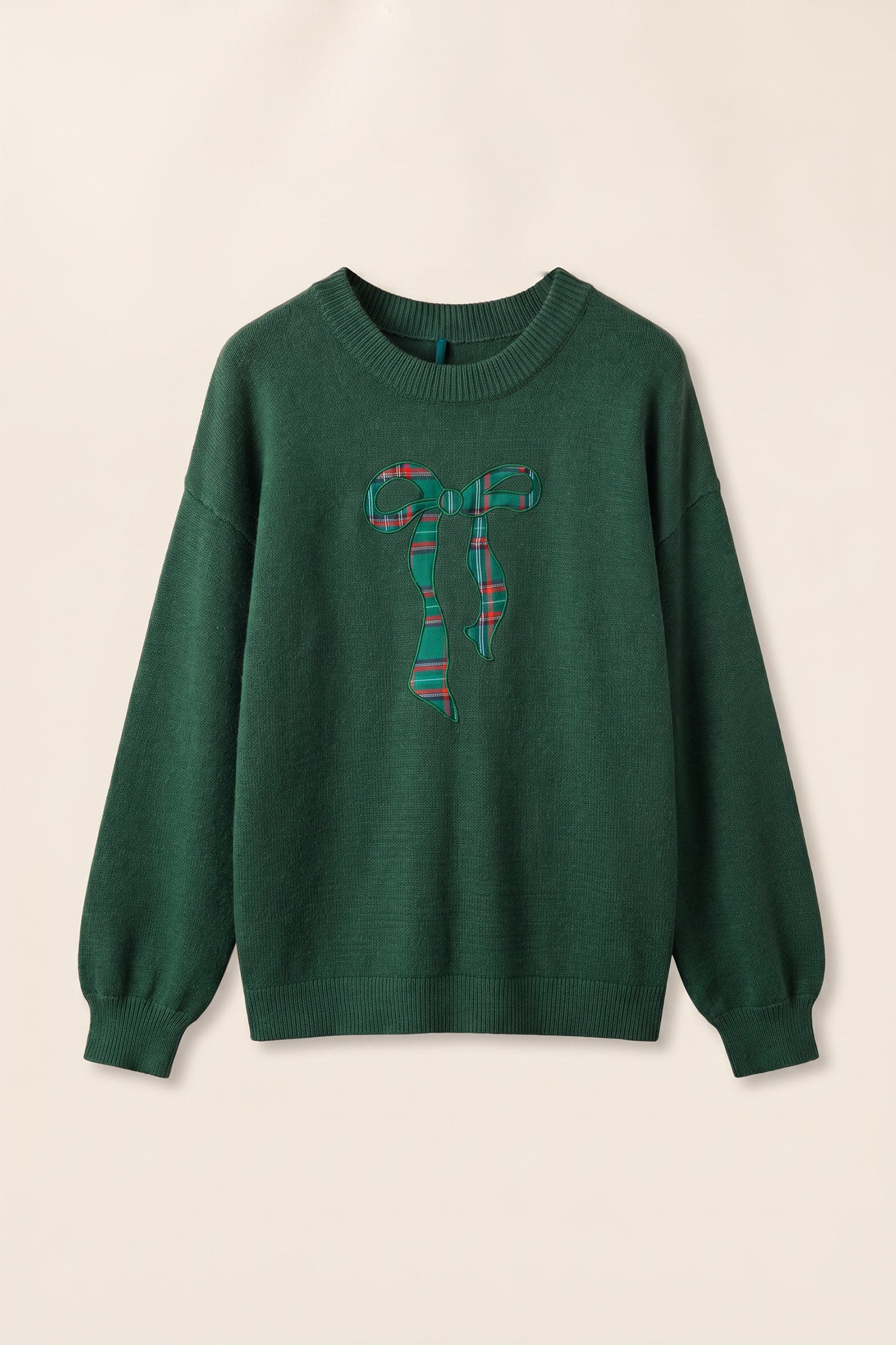 Dark green sweater with large red-green-blue plaid bow graphic on chest.