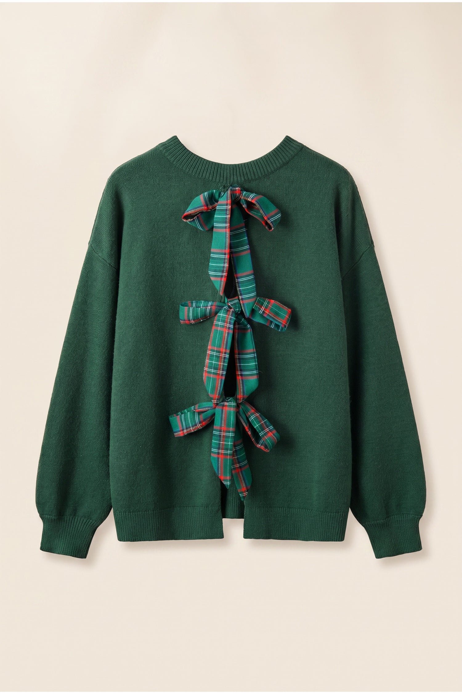 Dark green knit sweater with decorative plaid ribbon bow on front.