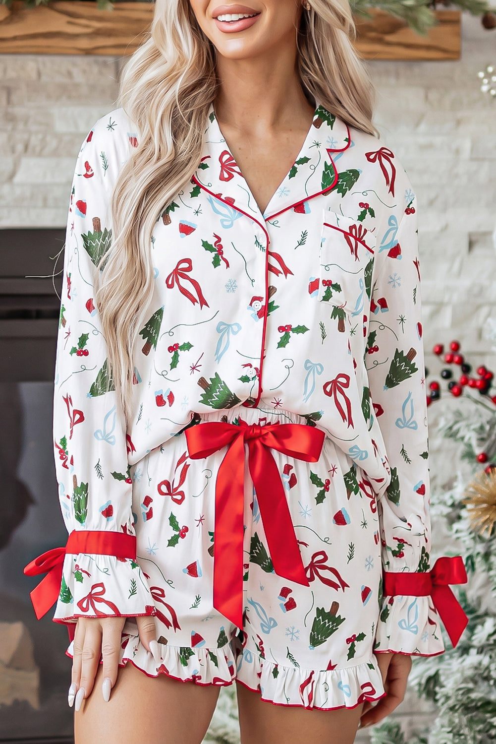 Woman wearing white Christmas-print pajamas with red waist tie and cuffs.