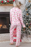 Back view of woman in pink Christmas pajamas with Santa, reindeer, and bows.