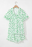 Green shamrock patterned pajama set on a hanger against a white background