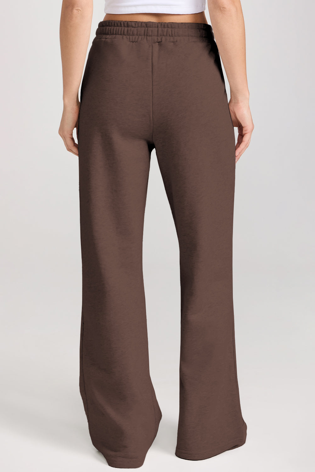 Brown wide-leg pants worn by a person on a white background