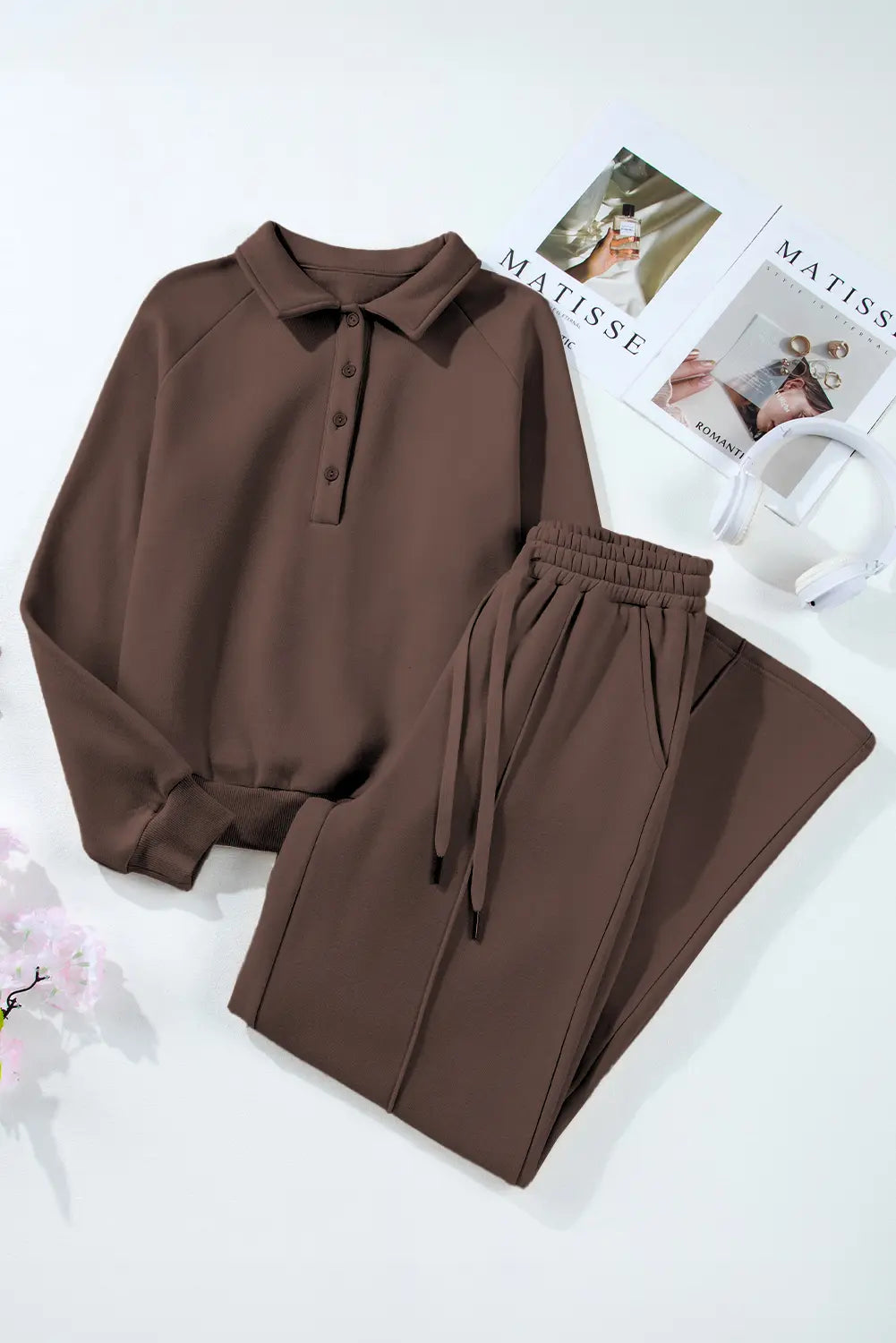 Brown outfit with a shirt and pants on a white surface 