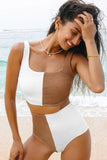 Woman wearing a white and brown swimsuit on a beach