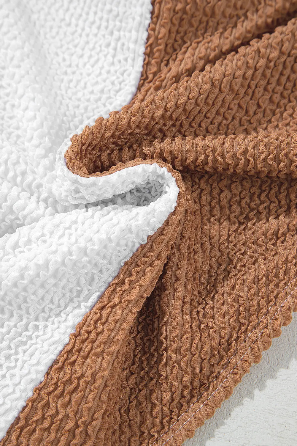Close-up of brown textured fabric on a white background